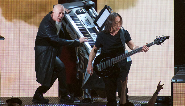 Jordan Rudess rocking out on his Korg Kronos, John Myung in front. Note the keyboard stand tilts and rotates.